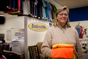 Kim Goodwin is the owner of EmbroidMe in Peoria. She has always enjoyed graphic design work and her Mom, who owned
 a fabric shop, suggested she get in the embroidery business. She likes helping people make their vision into a reality.