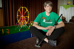 Ann Schmitt is the Curator of Education at Lakeview Museum in Peoria. 
 Working at the museum is 'like going to college forever... you never stop learning'. 
She is posing with the K’NEX miniature golf hole she helped to build for the ‘Fore the Fun of It' event at the Museum.