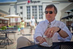 Larry Resutko relaxes at The Shoppes at Grand Prairie and enjoys an outdoor musical performance during his shopping trip.