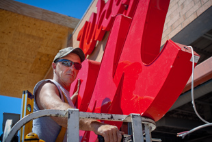 Robert Orsowy puts up the Walgreens sign on the new store on North Knoxville in Peoria.  He works for Prairie Signs and the company has installed 'lots' of Walgreens signs across central Illinois.