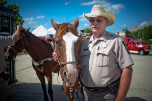 Jim Bunting, Captain of the Peoria County Sheriff's Mounted Posse Division is posing with Duke. 
They were part of the Seventh annual Emergency Expo at the Shoppes at Grand Prairie.