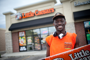 Cameron Okeke is a pre-med student at the University of Chicago.  He works at Little Caesars over the summers. He can be seen outside the restaurant attracting customers with some amazing dance moves, spinning a sign.