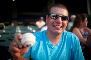 Eric Wildormoth and the foul ball he caught at the Peoria Chiefs game. 
 'I had to take out my brother to make the catch'. Eric is a farmer from Tremont, IL.