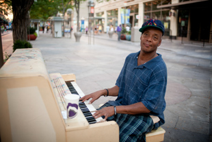 Dedrick Carpenter plays the piano on 16th street in downtown Denver CO.  
Dedrick, age 46, says he plays fairly often because he can make a few dollars.