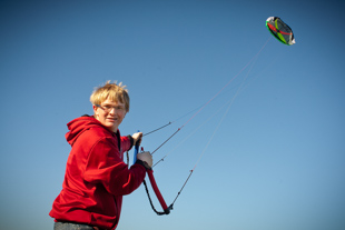 Logan Unser is flying his Power Kite.  He says it’s not a starter kite but one you have to work up to.  He also flies stunt kites. 
He recommends the hobby because it is a lot of fun and a big adrenalin rush, ‘it’s more exciting than it looks’.