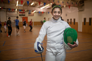 Huda Aldadah likes sports and her favorite sport is fencing.
  She has been practicing and training at Peoria Fencing Academy since she was a 2nd grader 
(she is now in 7th grade). ‘It takes a lot of practice and focus’, she said, ‘I like it because it is not ordinary’.