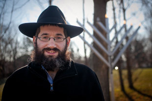 Rabbi Eli Langsam is the Director of the Lubavitch Chabad of Peoria. He and his wife, Sarah, have run the organization 
for 11 years. During this Chanukah season he wants to remind everyone that the Menorah 
is a symbol of religious freedom,of light defeating darkness and good prevailing over evil.