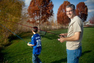 Pete Targos of Peoria is taking advantage of the warm fall day to take his sons fishing.
  They are trying their luck at the pond in Northtrail Park.