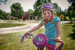 Addisyn Smet (age 6) is at the Peoria Park District bicycle safety town.
 She has brought along her dad, Steve, and her brother, Collin.
They said they usually come a couple times each year.