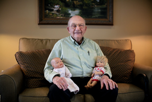 Roy Roth lives at The Apostolic Christian Home of Eureka, he is being visited by his grandchildren
 (who asked him to hold their dolls). ‘They are busy with their life, I am thankful when they have time to visit’, he said. 
 He said he operated an 18 wheeler for 58 years and is now 87.