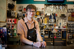 Chris Wheeler is a bicycle mechanic at Bushwacker in Peoria. He likes to ride also, going on long distance rides 
and bicycle tours. Working on his own bike got him interested in doing it as a job.
